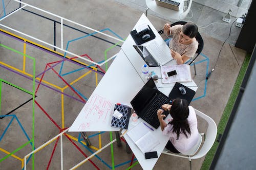 Two Women Sitting in Chairs Using Laptop Computers, local seo philippines,